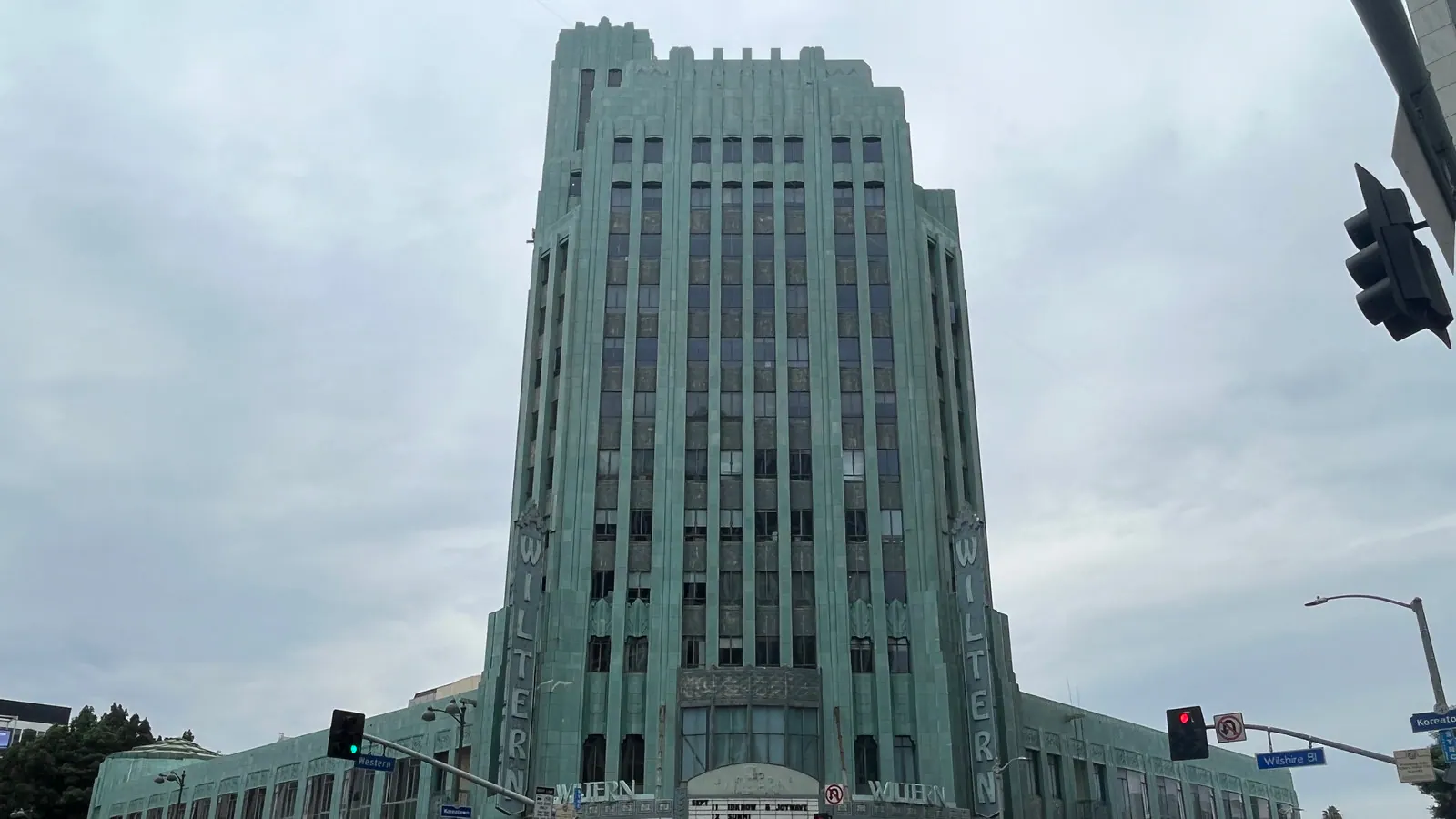 Wide street view of the Wiltern's Art Deco tower and facade at Wilshire and Western in Los Angeles.