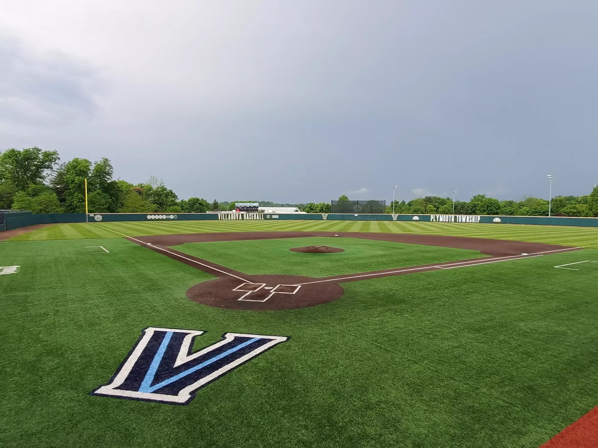 Villanova Ballpark at Plymouth’s renovated infield and grass outfield on a rainy day in the current official facility collection. This actual elevated view is distinct from the older 2015 natural-grass lead; no exact capture day or numbered spectator camera seat is supplied.