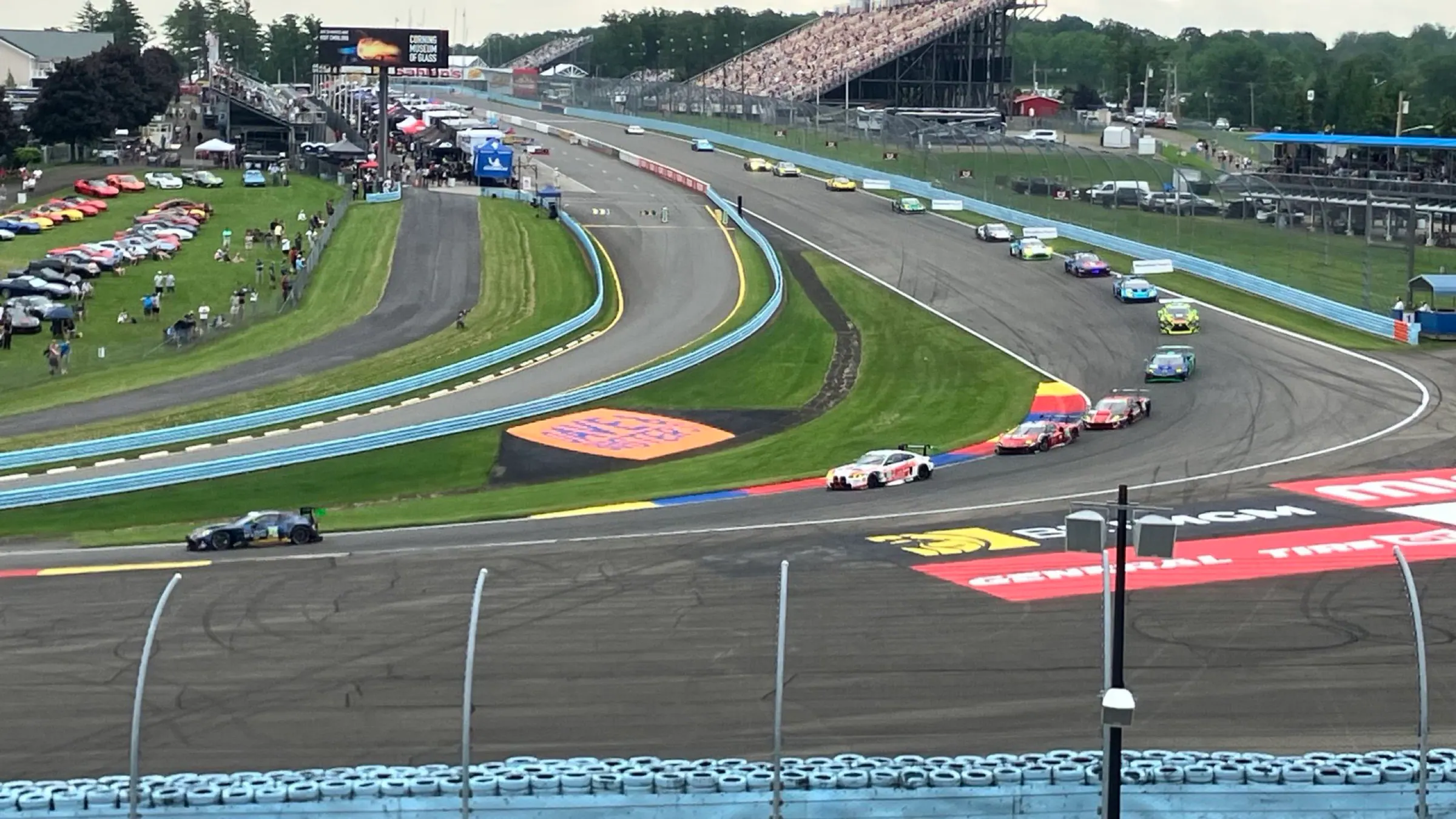 Wide view of racing through turn one at Watkins Glen International.