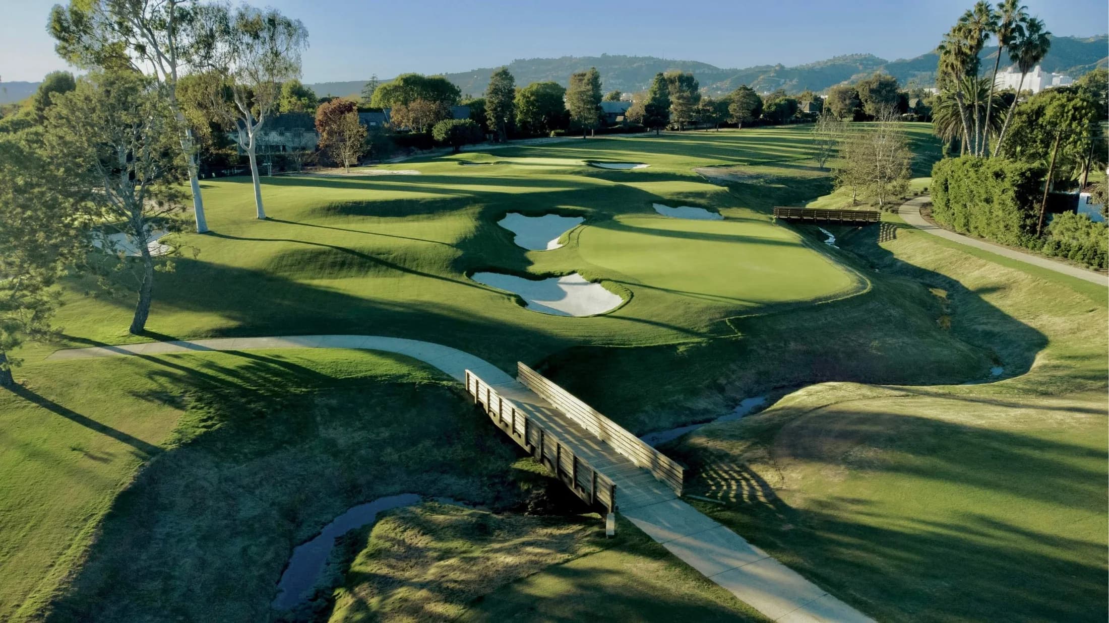 Wilshire Country Club — bridge, bunkers and green in the club’s public course photograph. The owner does not identify the hole or capture date; the image is general course context.