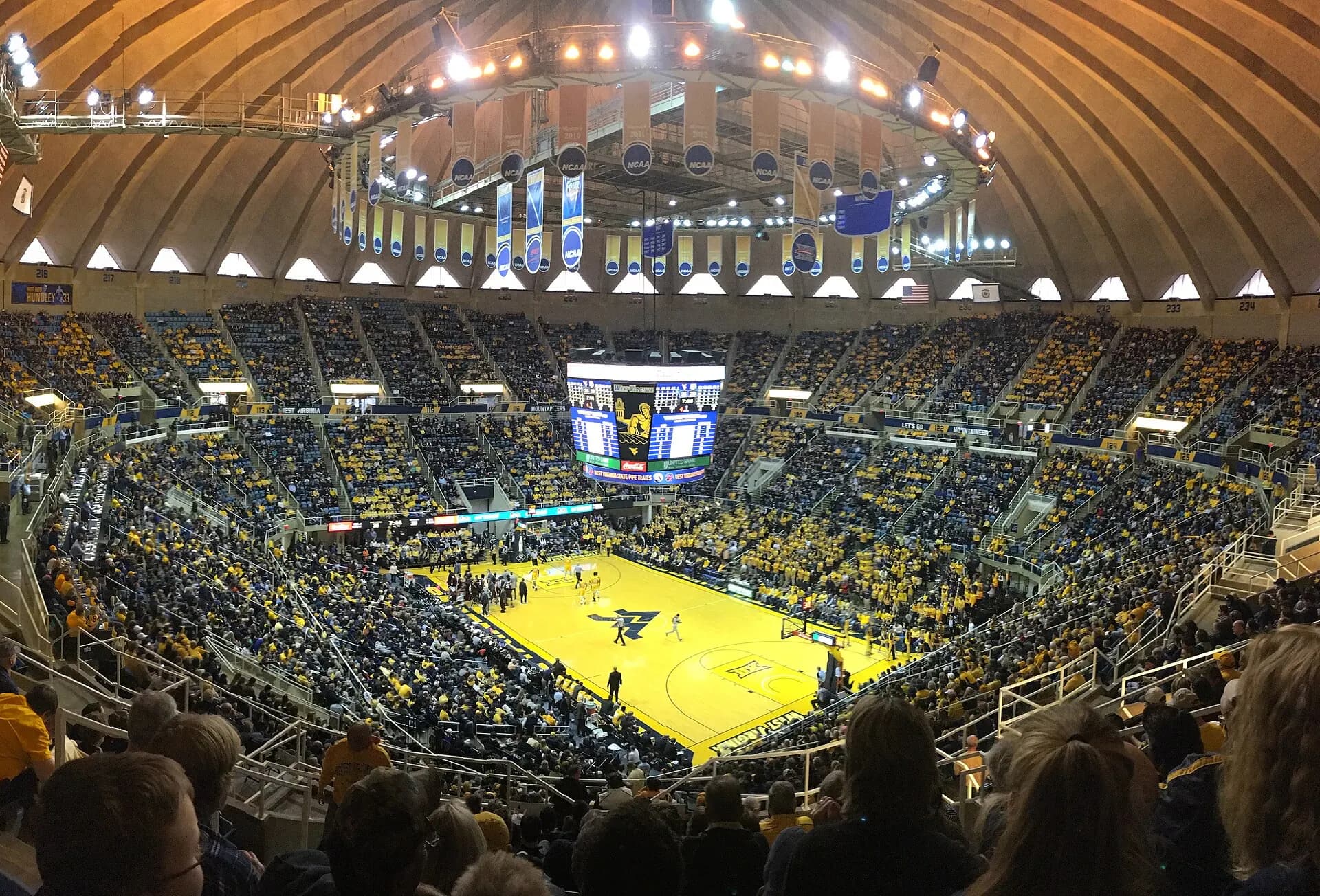 Packed basketball crowd surrounding the court inside Hope Coliseum.
